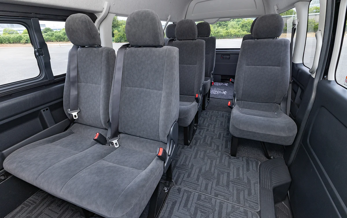 Spacious interior and comfortable seating inside a Toyota Hiace passenger van