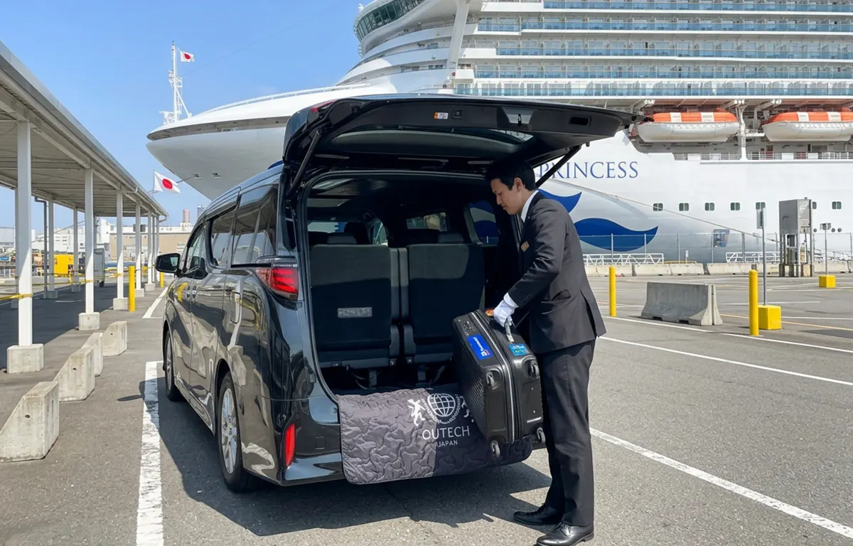 Chauffeur loading luggage into a private transfer van